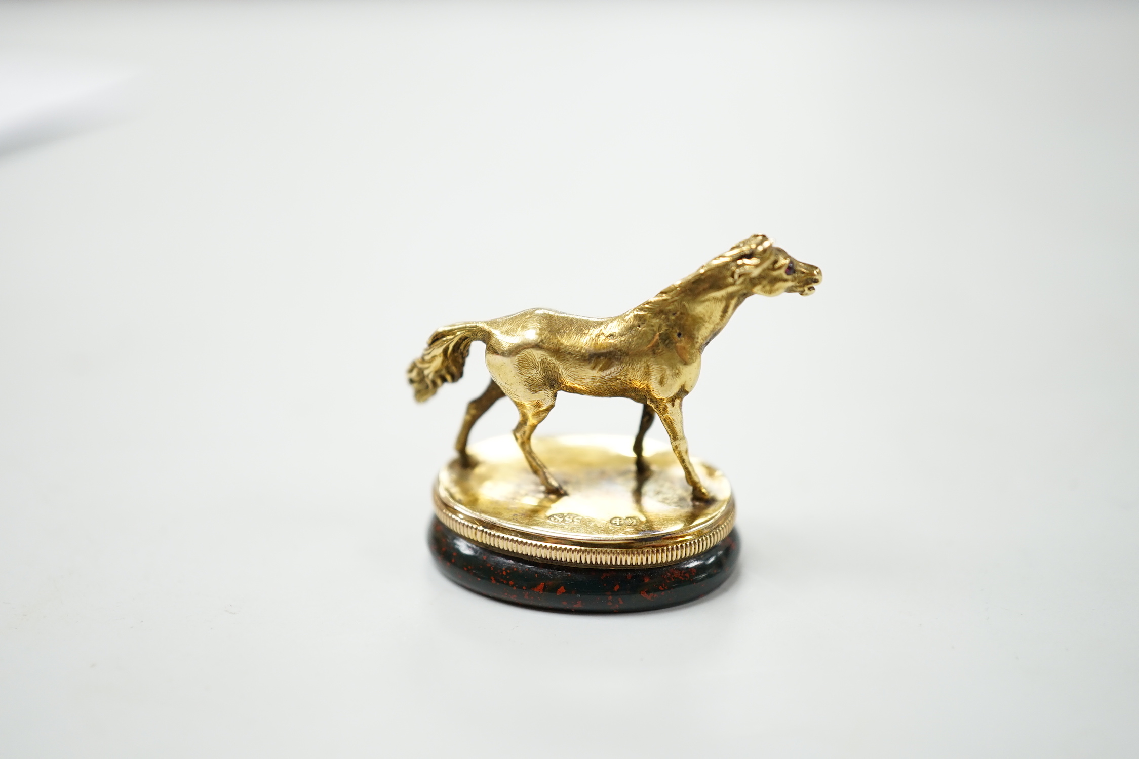 An early 20th century yellow metal and bloodstone set seal, with horse surmount